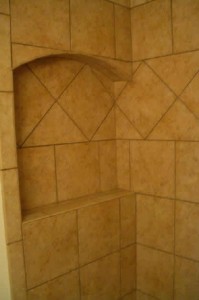 Ceramic corner niche with arched top and frame. On-point tile throughout Ceramic corner niche with arched top and frame. On-point tile throughout