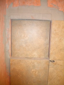 Placing the back wall tile in the niche Placing the back wall tile in the niche