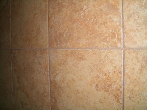 Control joint installed through a tile installation