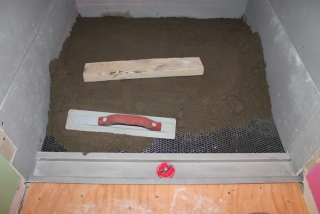 Installing the mud deck with a laticrete linear drain